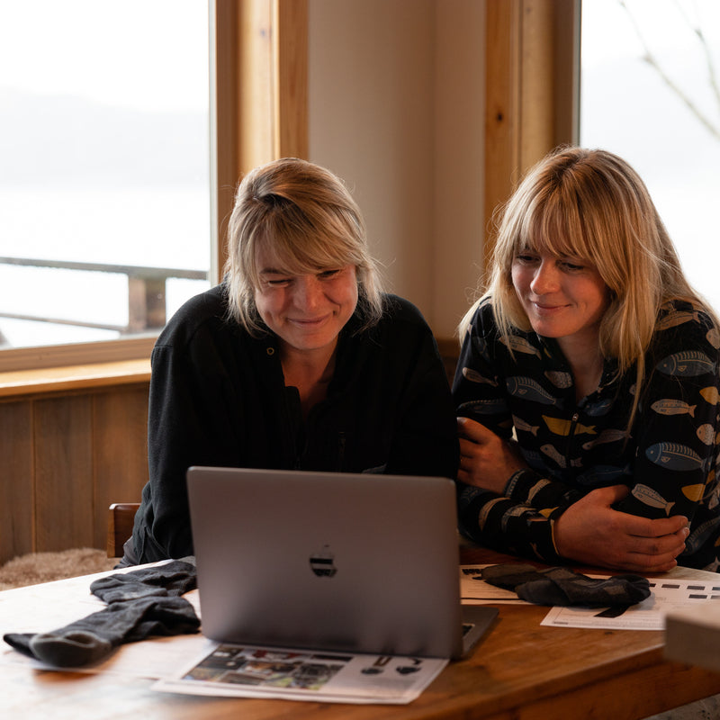 Emma and Claire, the Salmon Sisters, video calling with Darn Tough designers while looking at test socks