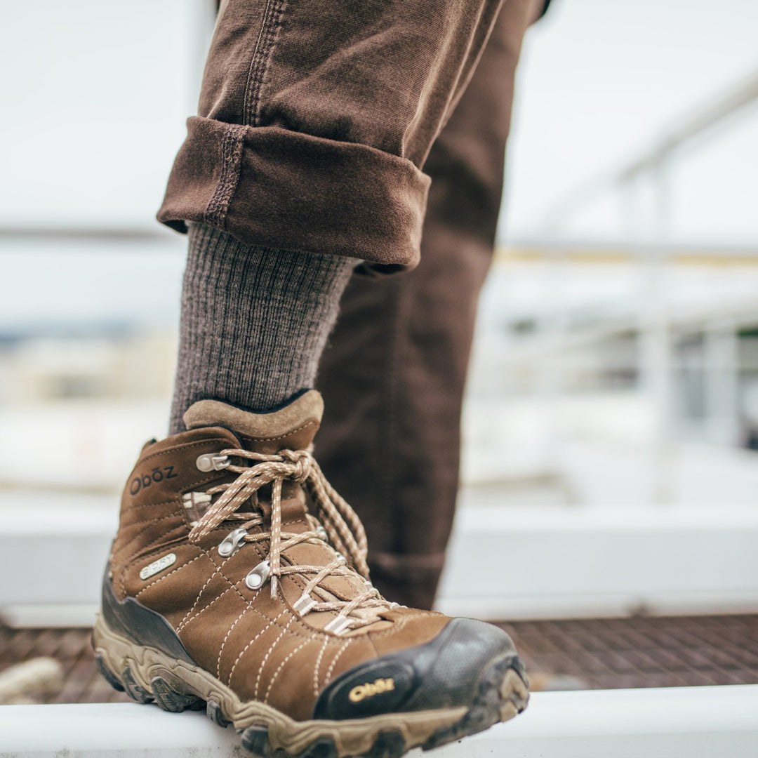 Foot wearing darn tough socks for work in brown work boots