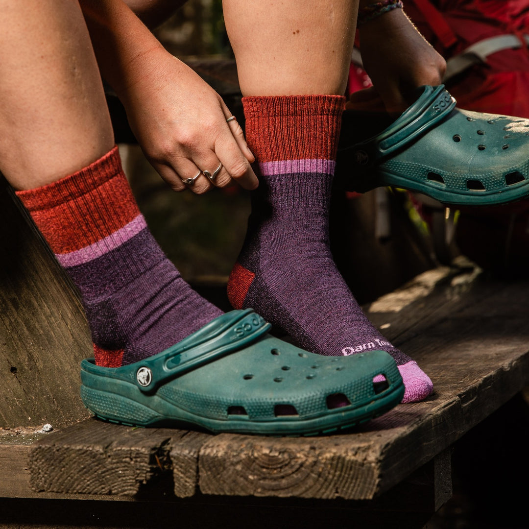 Feet wearing our softest socks, the twisted yarn ranger socks, with some crocs for extra comfort