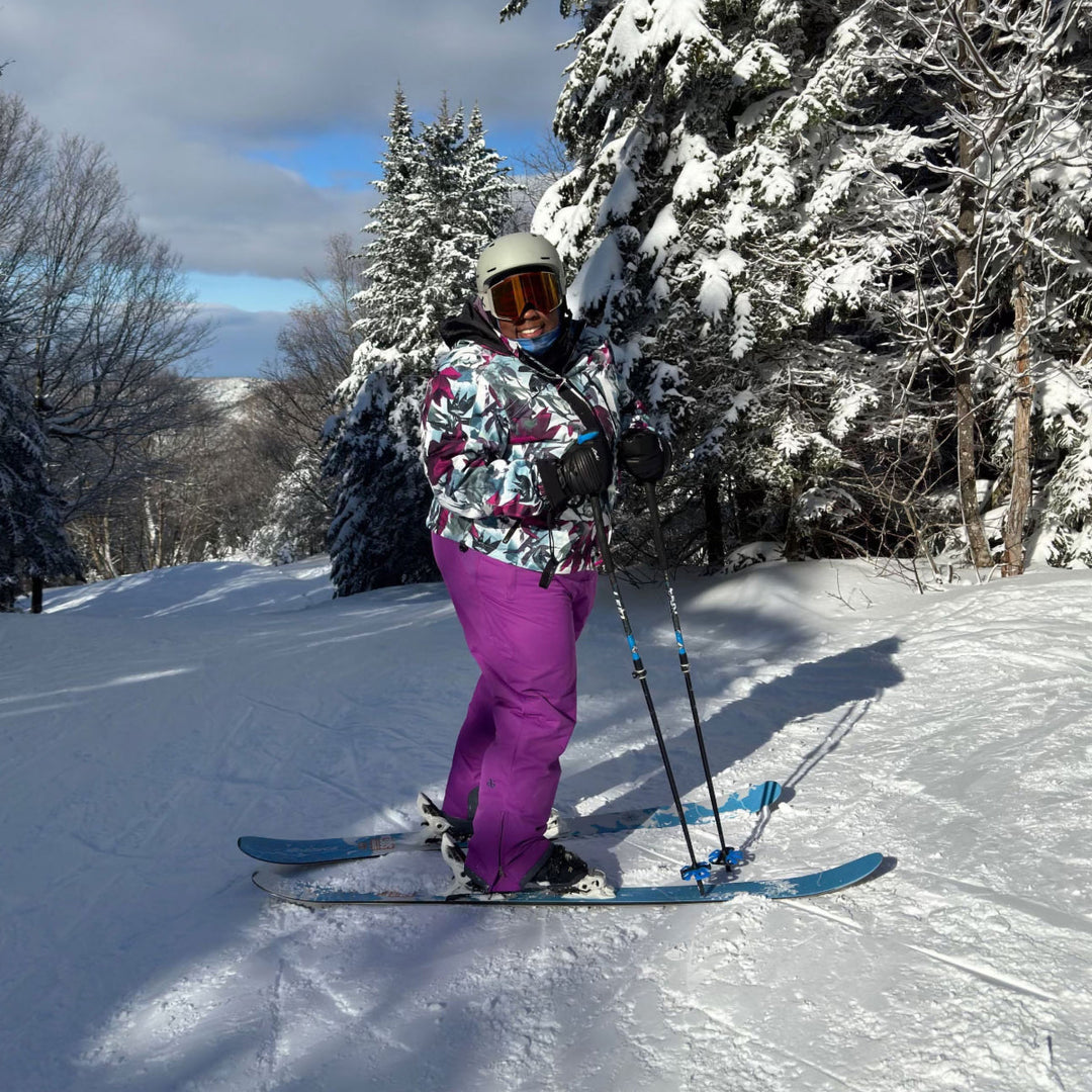 Mirna Valerio out on her skis smiling before she heads down the mountain