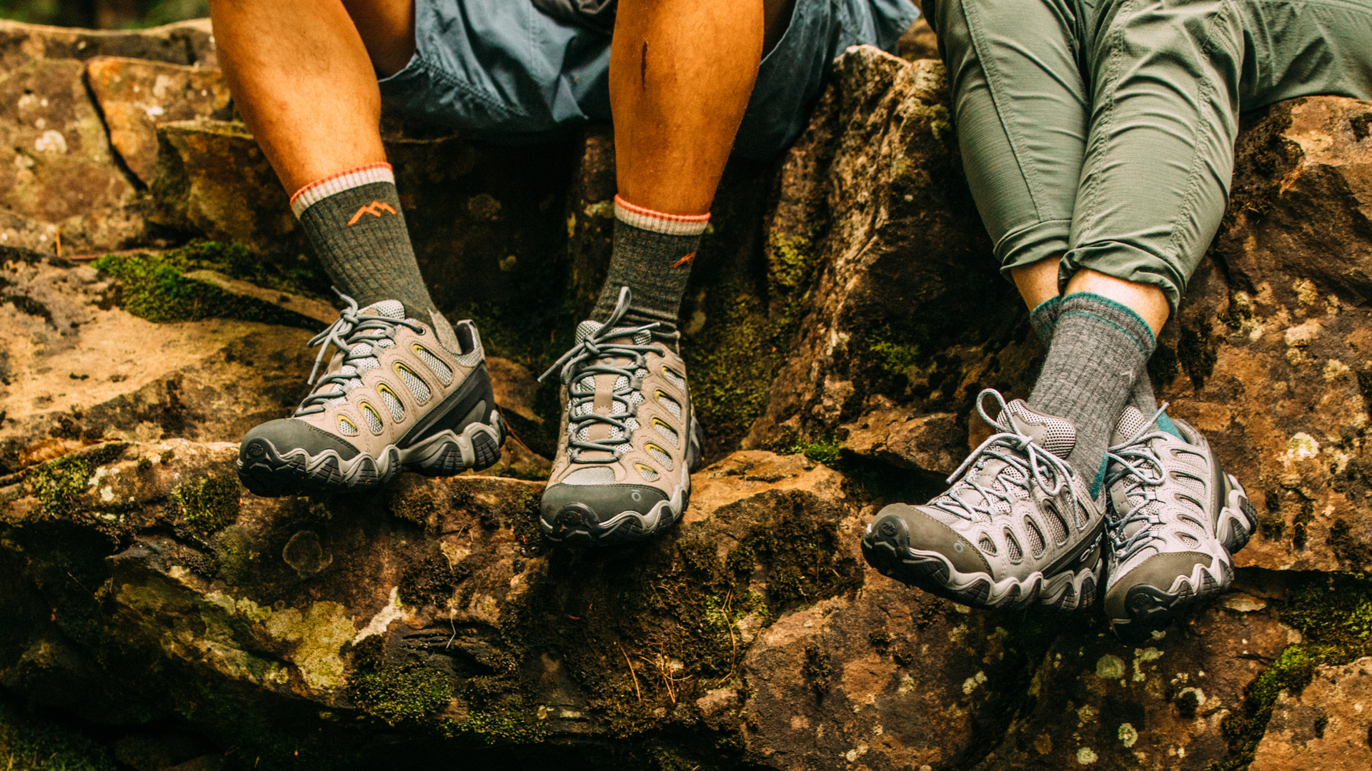 Colse up of men and women's feet on rocky ledge . men's 1466 Micro crew and women's 1903 micro crew featured.