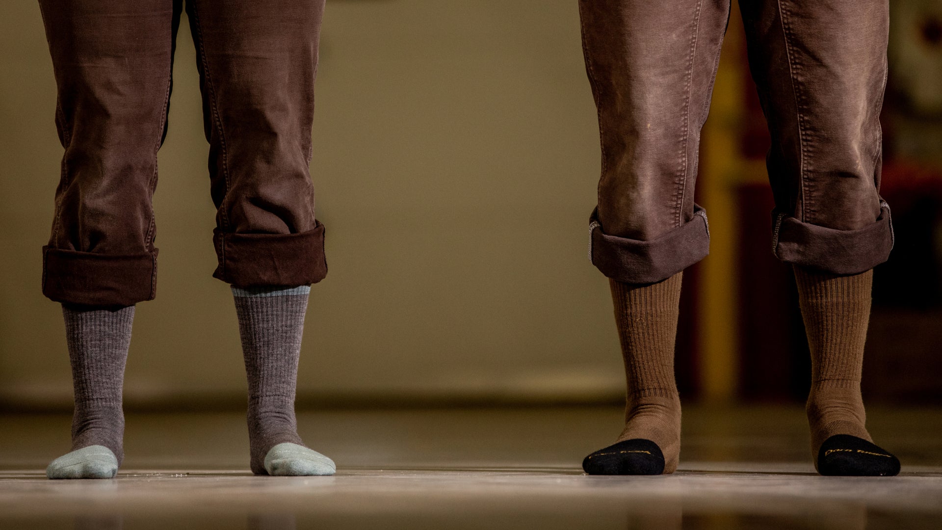 Left side women's steely boot sock on model and right side men's steely boot sock on model.