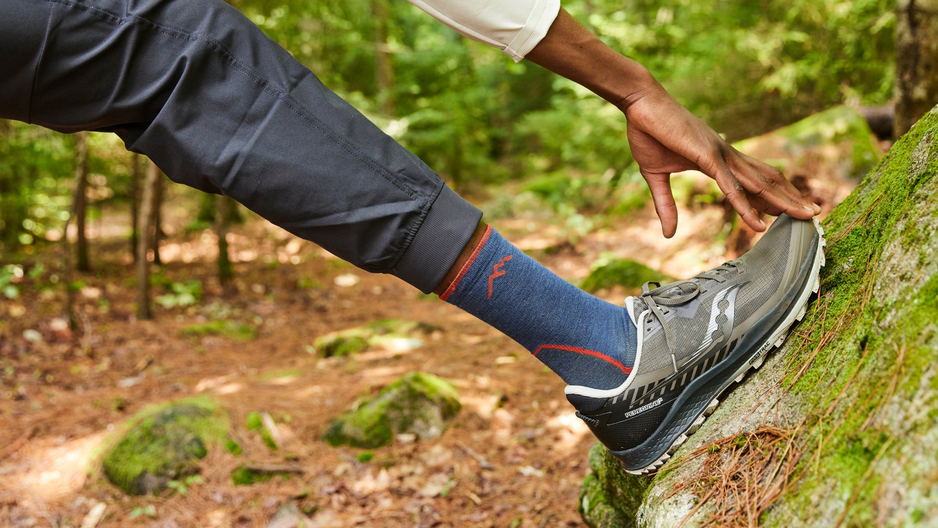 Model extending foot while featuring the 1952 Light Hiker