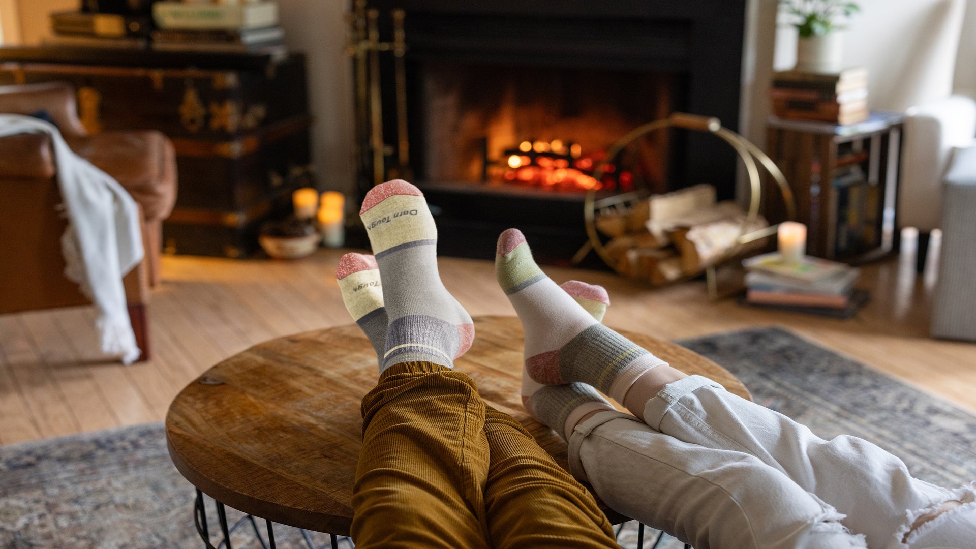 A couple of hikers sitting on a rock wearing hiking boots and darn tough hiking socks, the perfect matching couples gifts for valentines day