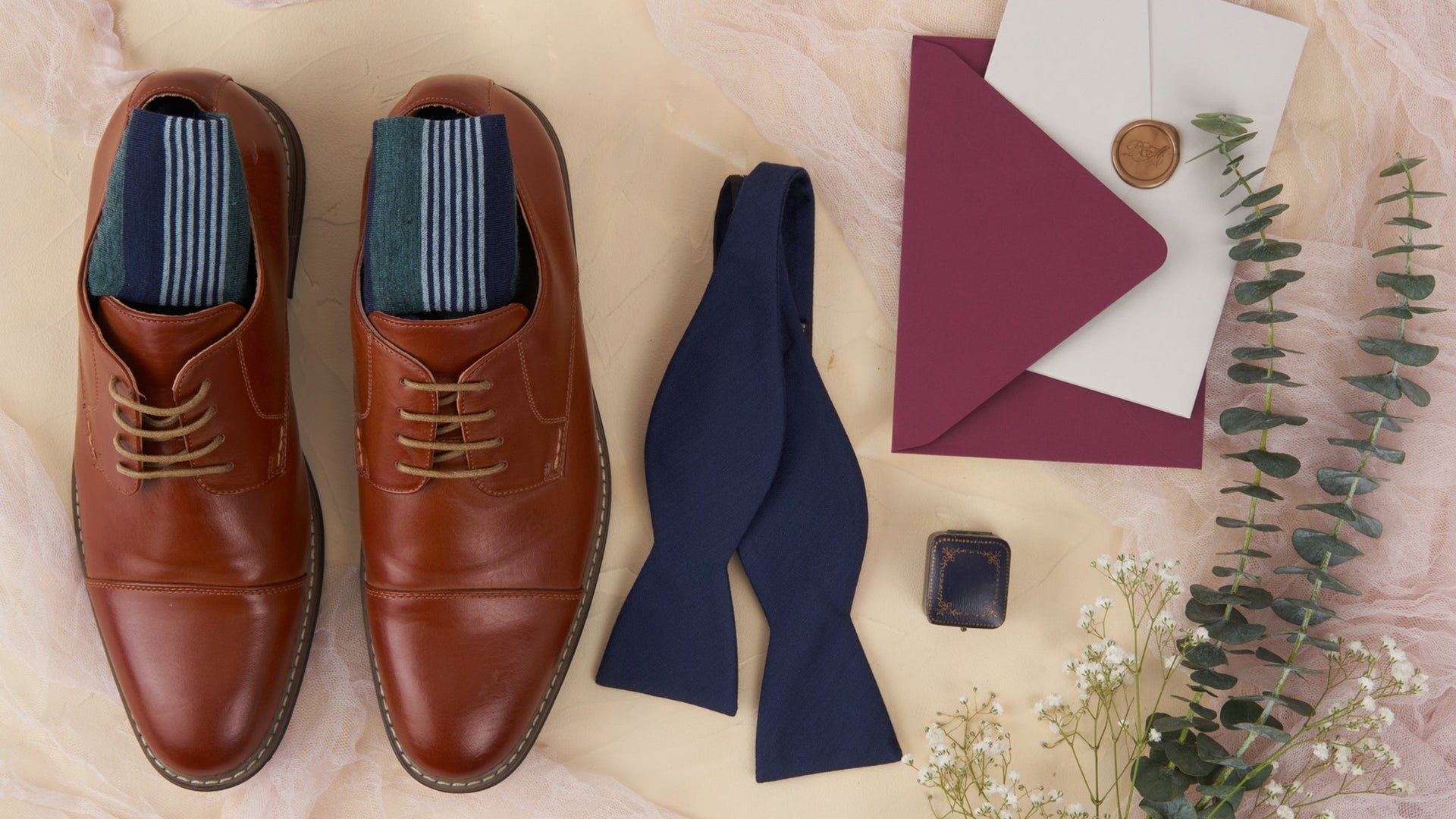 men's dress shoes with dress socks in them with a tie and invitation