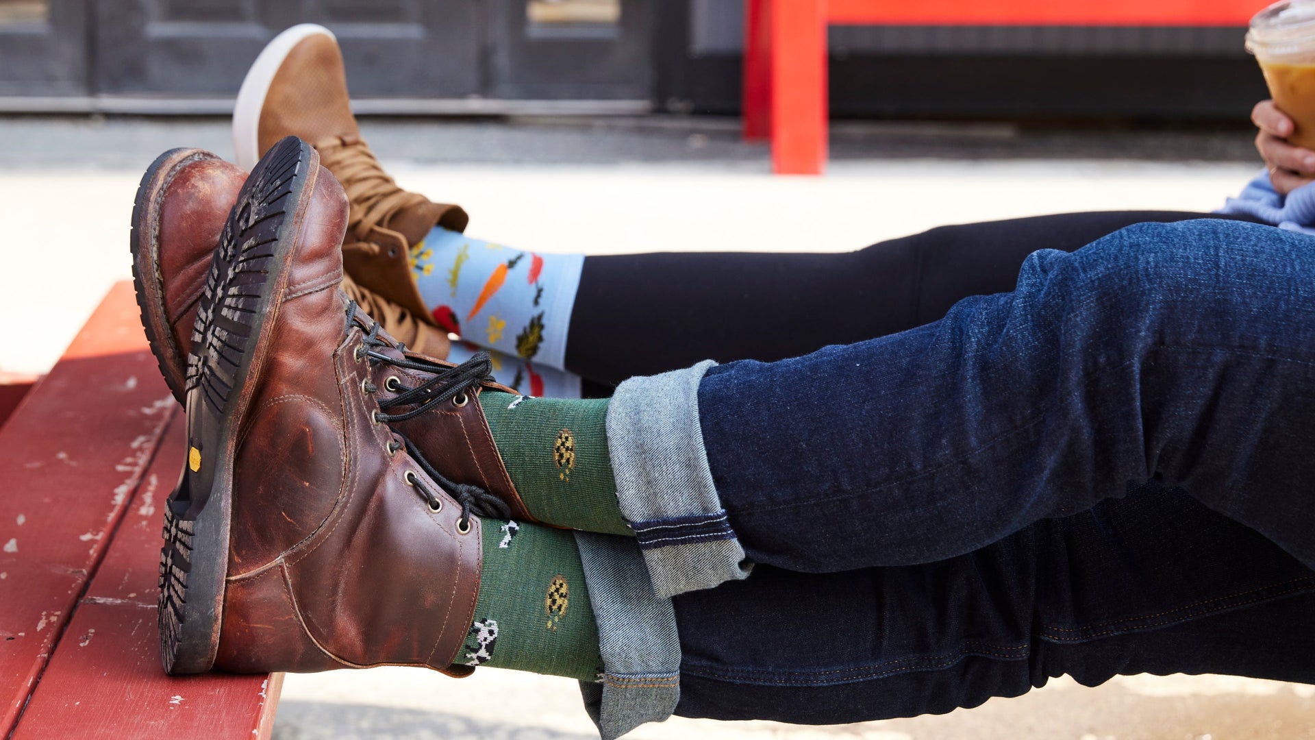 Two model sitting with feet up wearing the 6116 Dairy air and the 6054 farmers market