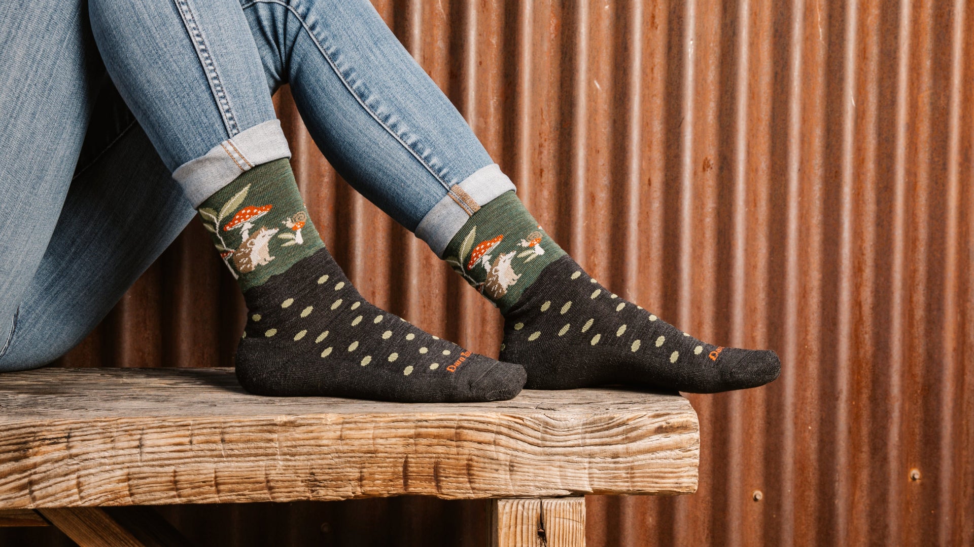 model with feet up on wood bench wearing the wildlife crew in hedgehog moss