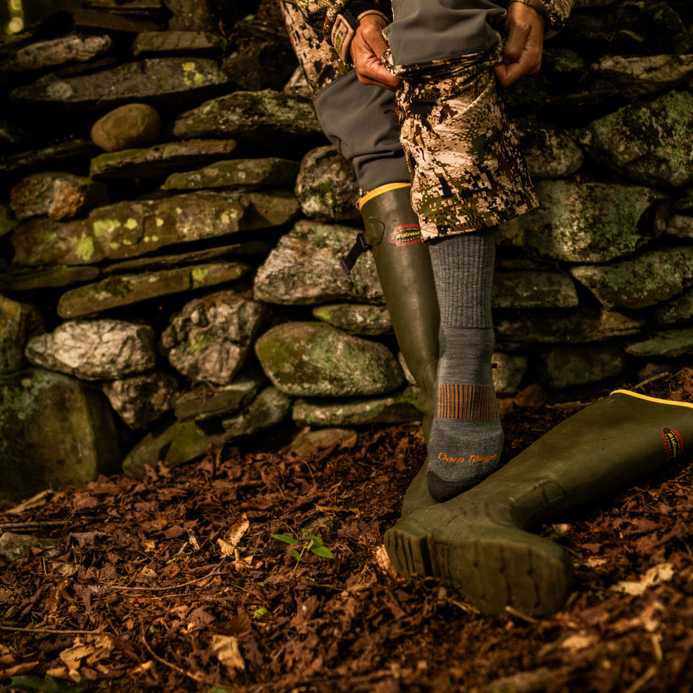 close up on model image of 2107 seafoam while putting on boots
