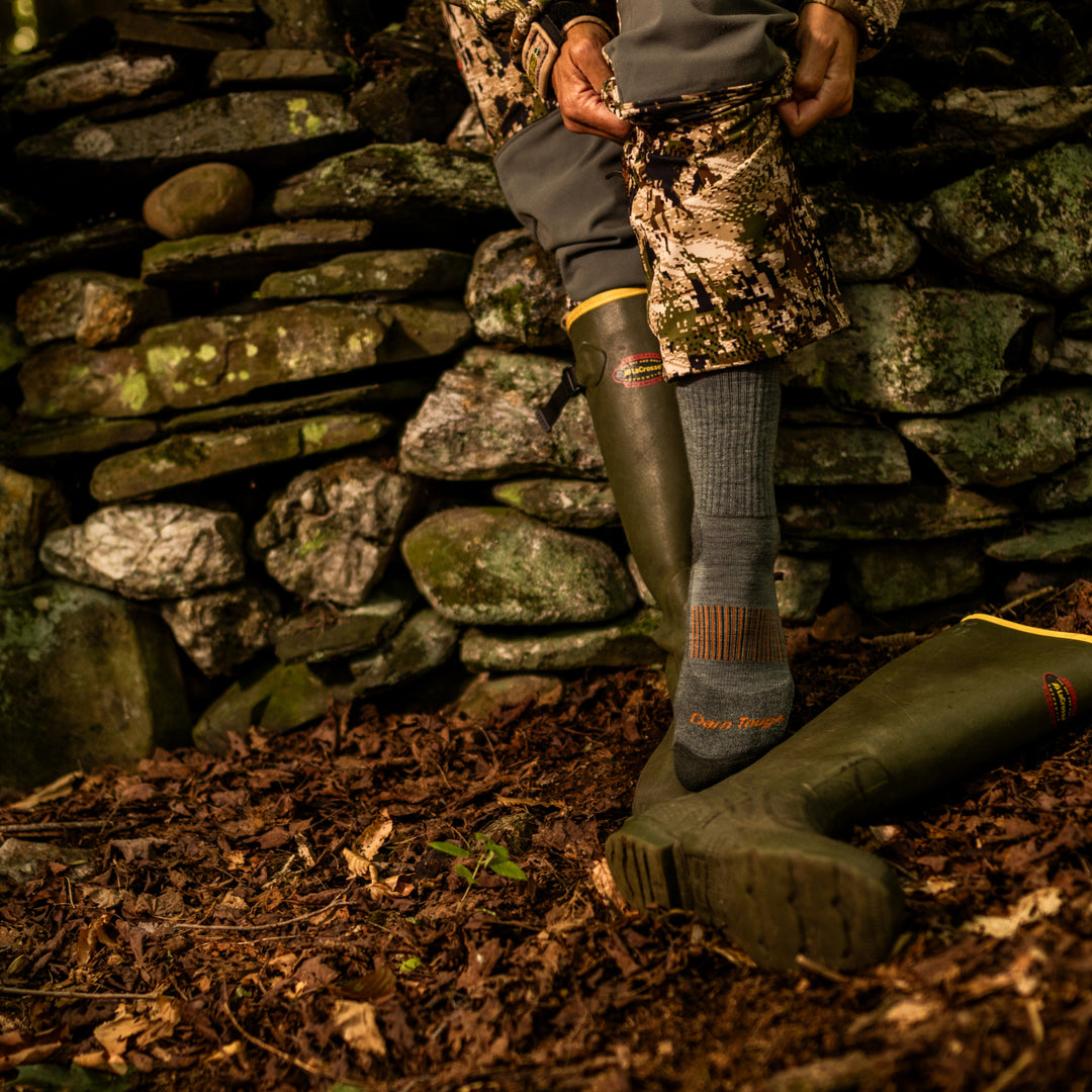 close up on model image of 2107 seafoam while putting on boots