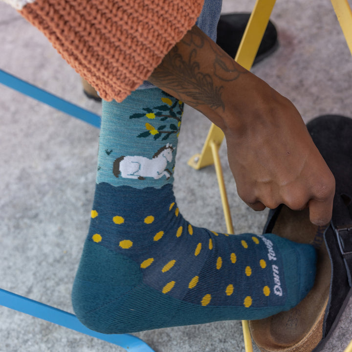 close up of model removing her sandal wearing the 6105 Dark Teal