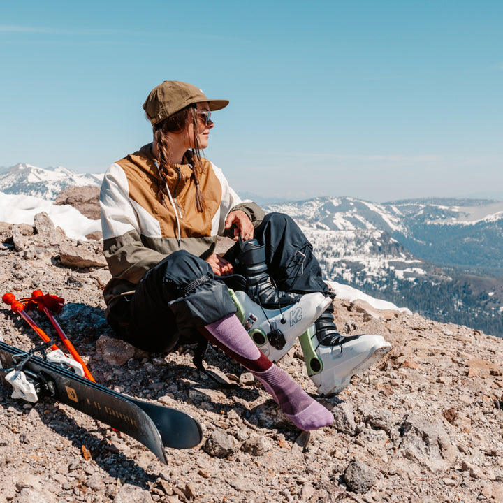 model sitting on rock atop mountain wearing 8038 burgundy