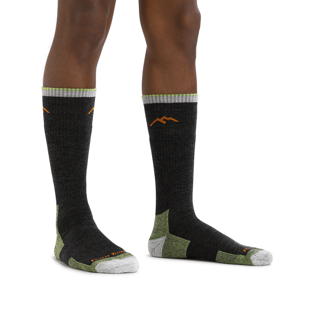 Close image of man standing barefoot wearing Hiker Boot Midweight Hiking socks with Cushion in Lime