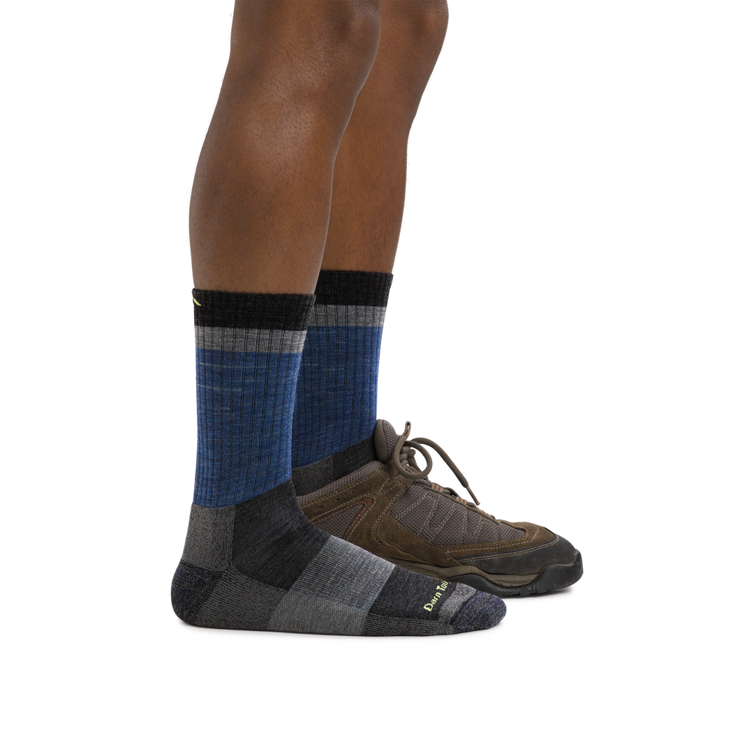 Man wearing Heady Stripe Micro Crew Hiking Socks in blue and on back foot also wearing a hiking shoe