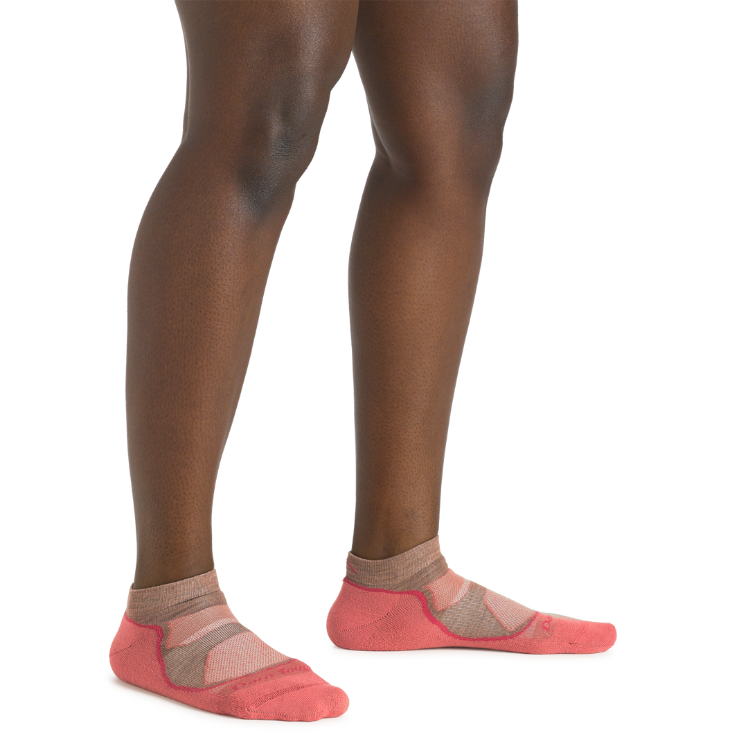 Close up shot of model wearing the women's light hiker no show hiking sock in canyon colorway with no shoes on