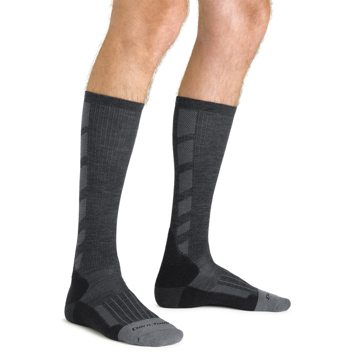 Close up studio shot of model wearing men's stanley k mid-calf lightweight work sock in gravel gray