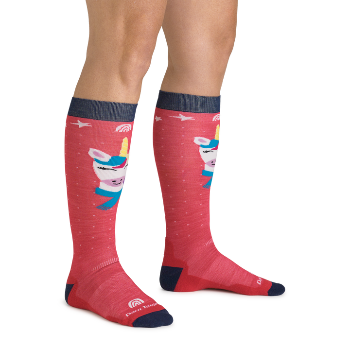 Side studio shot of model wearing kid's magic mountain over-the-calf ski sock in raspberry