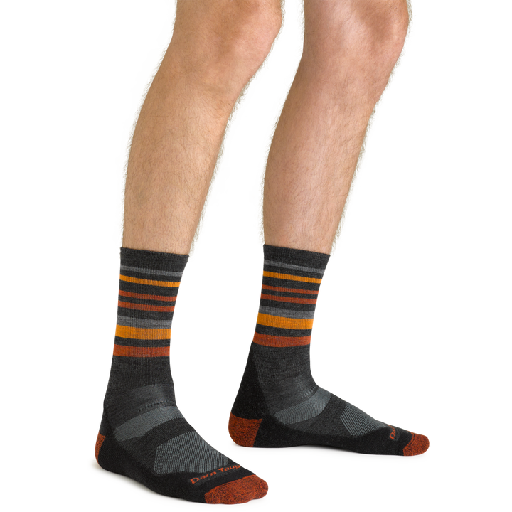 Close up shot of model wearing the men's fastpack micro crew hiking socks in charcoal with no shoes on