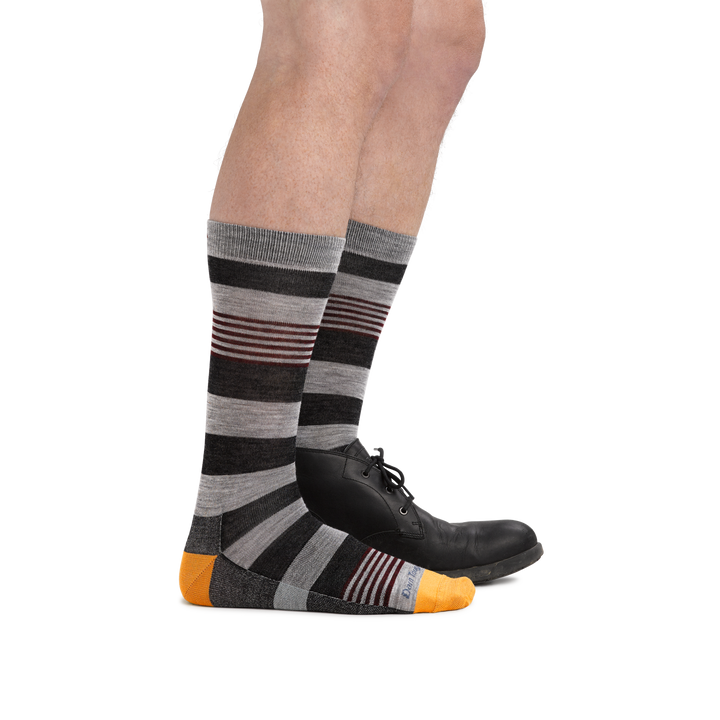 Male legs facing right wearing Oxford Crew Lightweight Lifestyle Socks in Gray, with back foot in a dress shoe