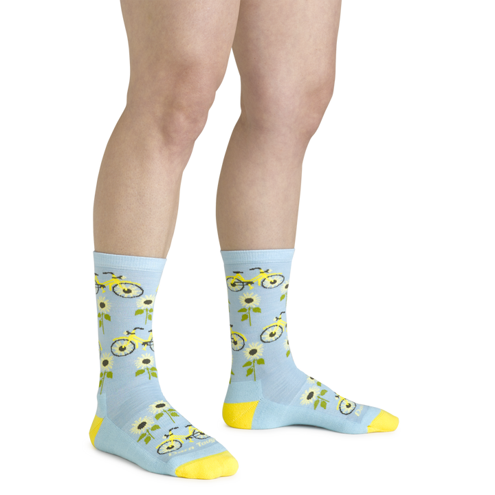 Close up shot of model wearing the women's sun pedal crew lifestyle sock iin glacier blue with no shoes on