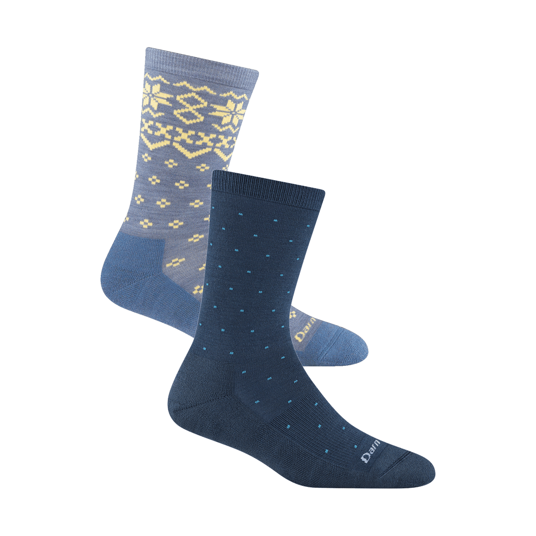 Image of a navy sock with blue pin dots and ight blue sock with cream faire isle pattern slightly behind it