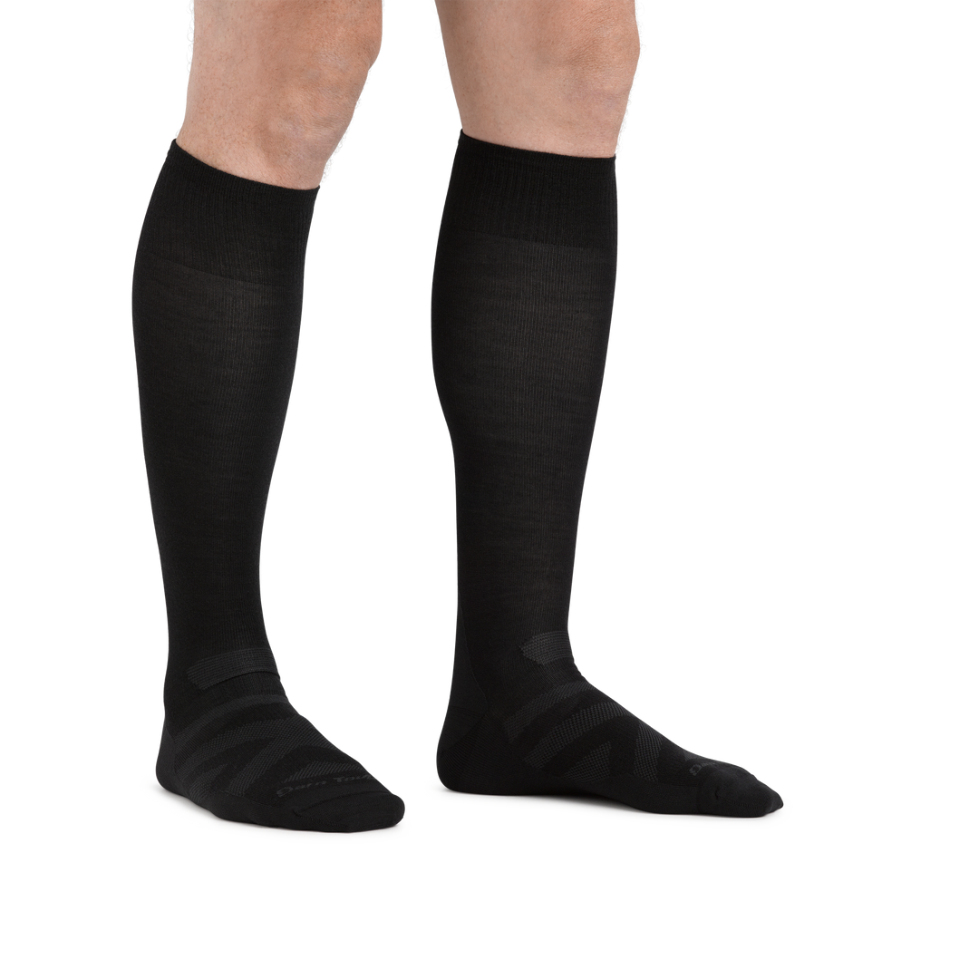 Man standing barefoot wearing RFL Over the Calf Ultralightweight Ski & Snowboard Sock in Black