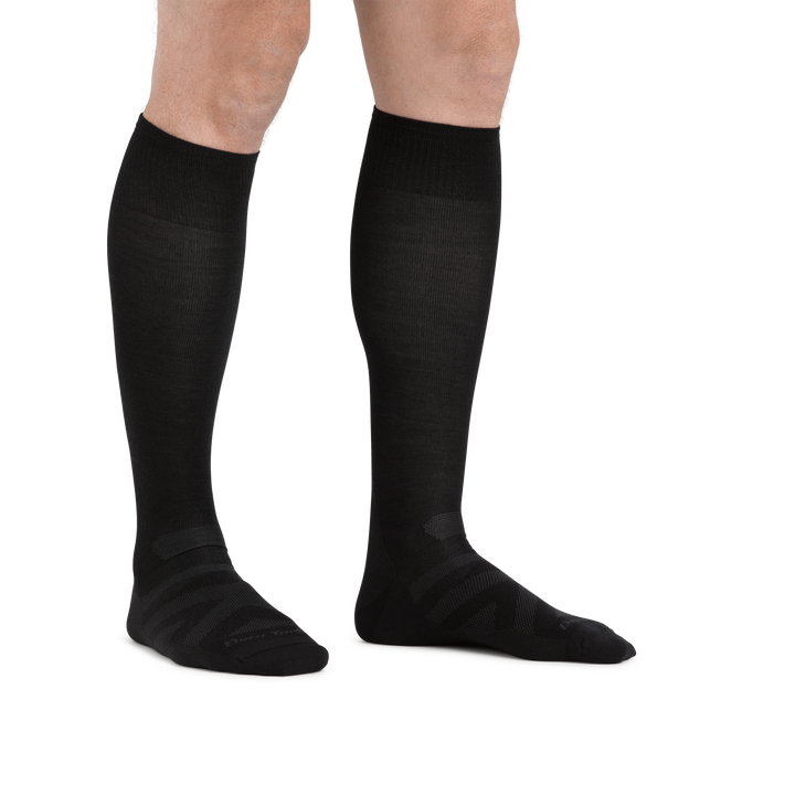 Man standing barefoot wearing RFL Over the Calf Ultralightweight Ski & Snowboard Sock in Black