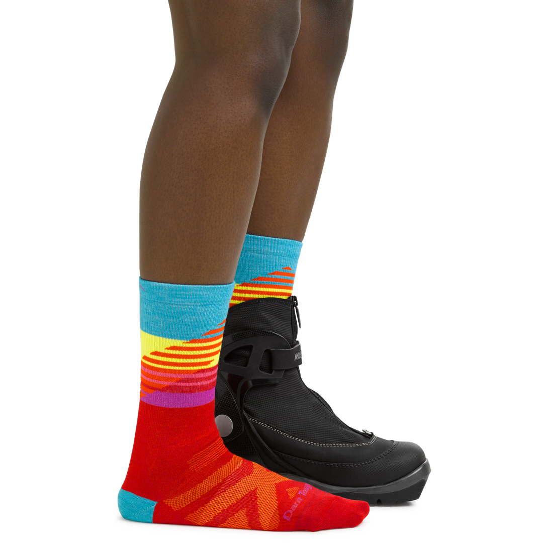 Women's Lillehammer Nordic Ski Socks in Red on foot with cross country ski boots