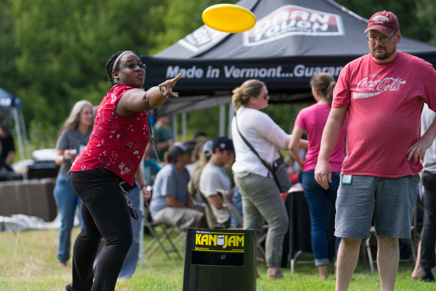 An employee tossing a Frisbee at the company picnic