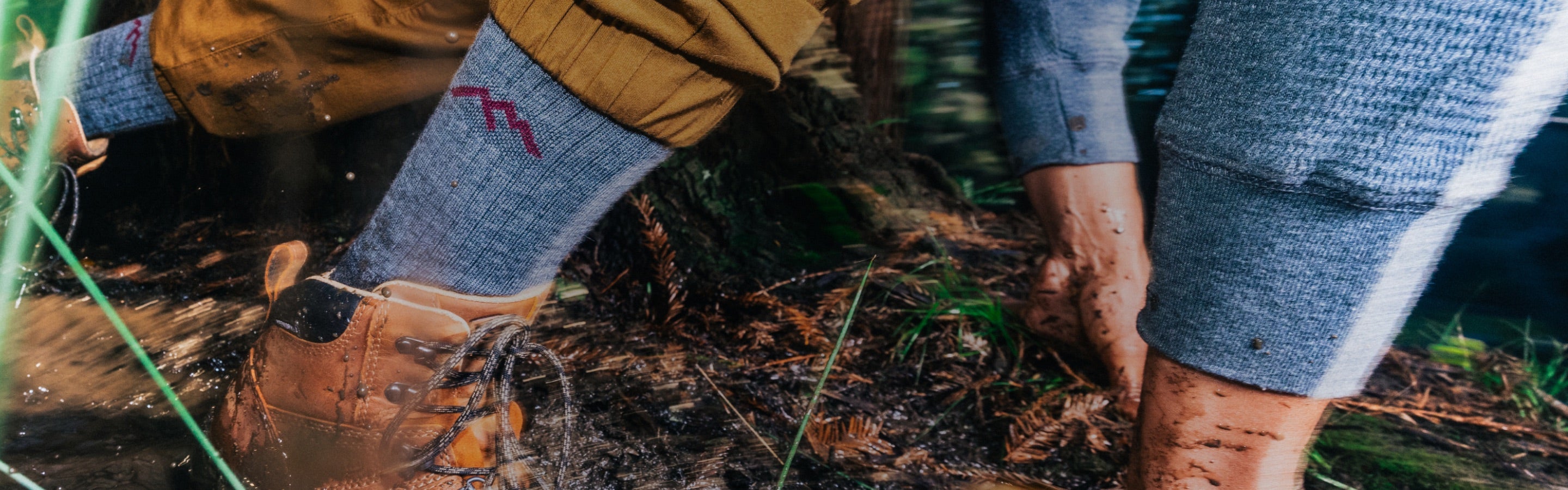 A hiker wearing darn tough socks tripping on a very muddy trail