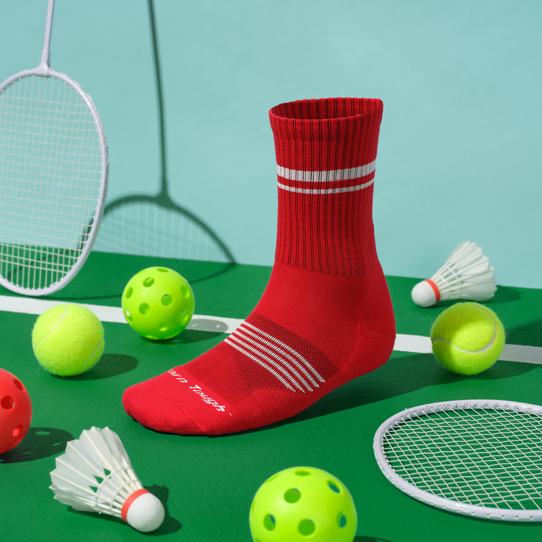 Sock form image of the 1118 Element micro crew with bat mitten rackets and birdies and tennis balls around it