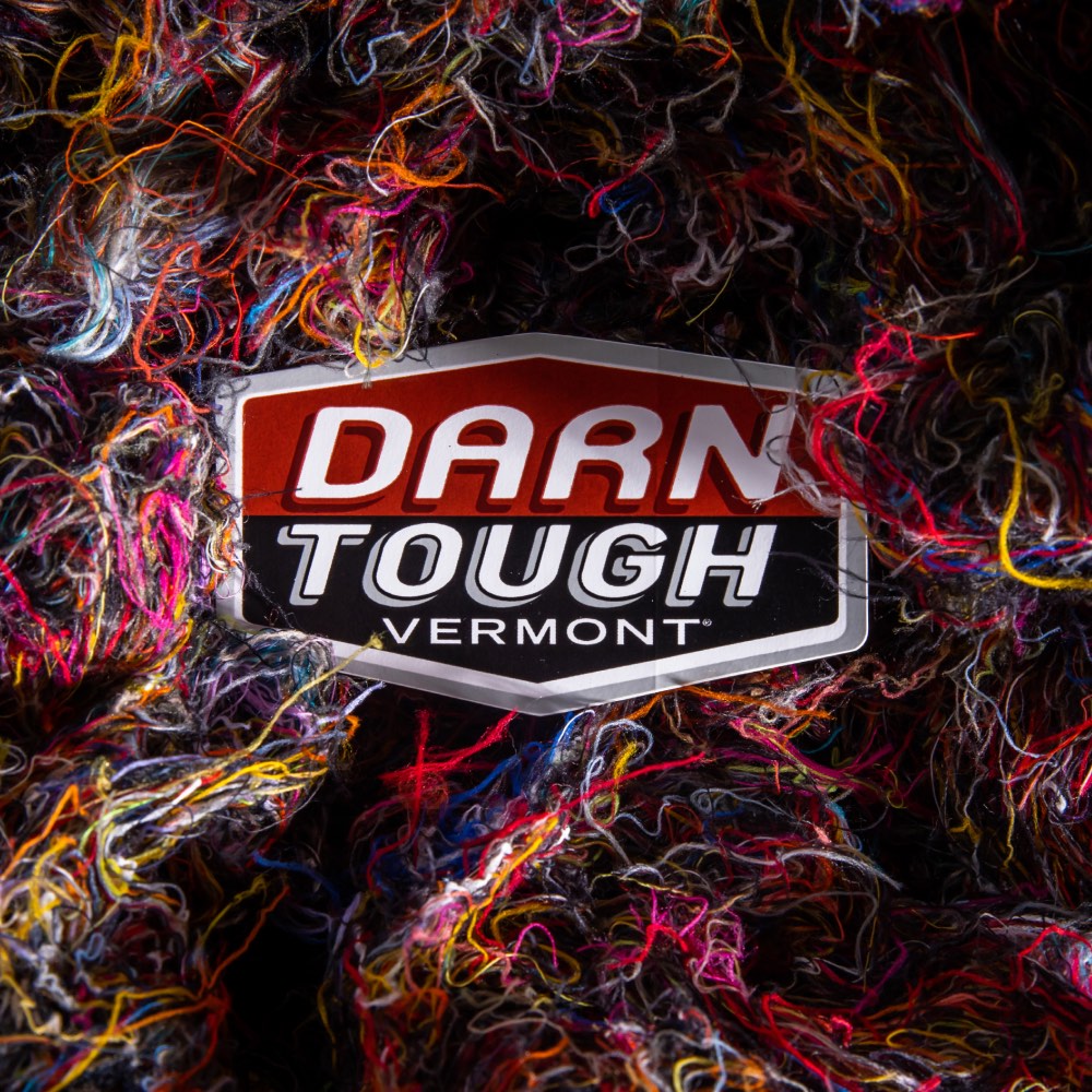 Darn Tough sticker logo among Merino Wool fibers from making merino wool socks