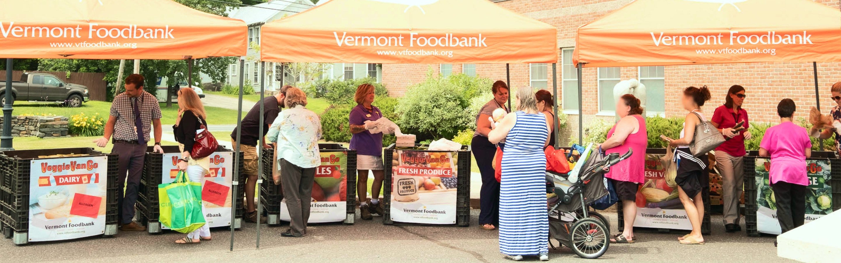 Booths of the Vermont Foodbank setup in the community, giving out food to those in need