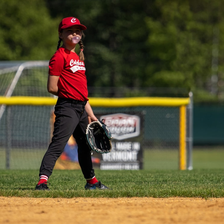 A youth baseball player out in the field 