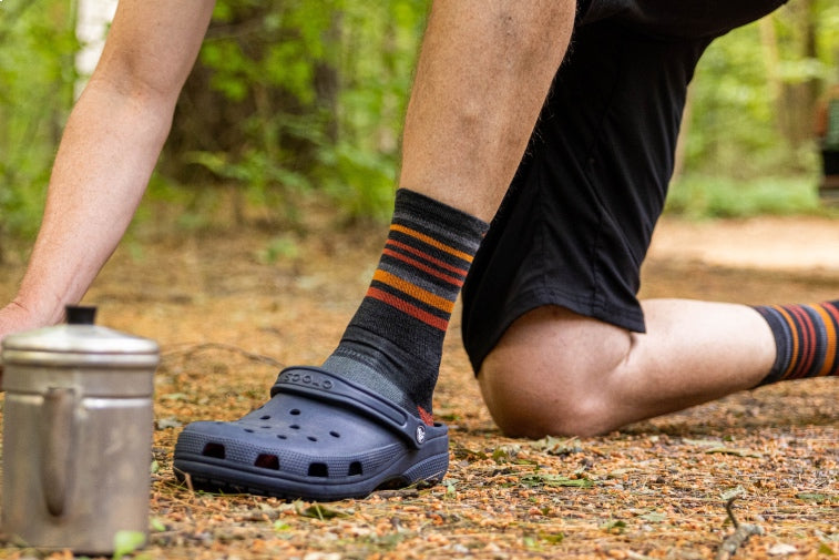 Shop New Socks - feet in striped hiking socks wearing crocs