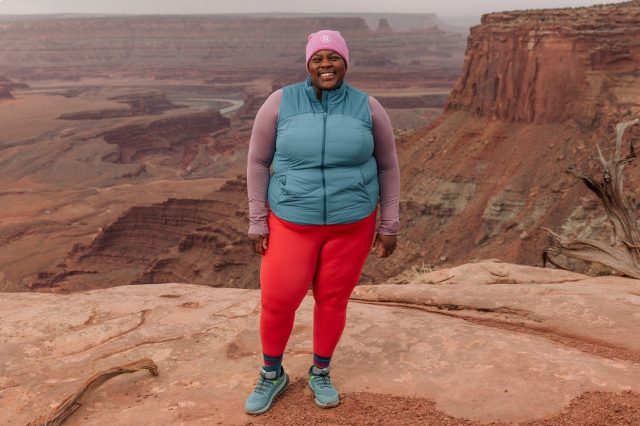 Athlete Mirna Valerio paused on an epic trail run wearing the Mirnavated run sock she helped design