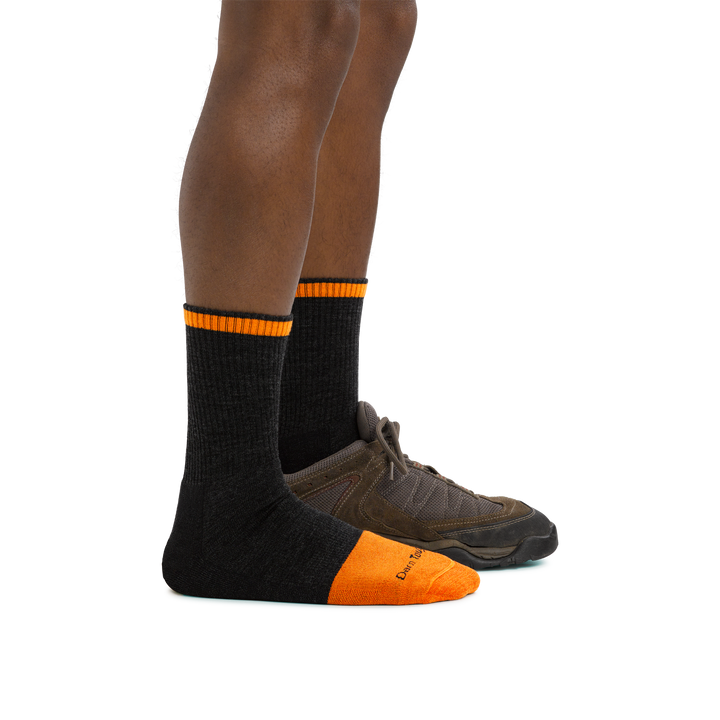 Man standing facing to the right wearing Steely Micro Crew Midweight Work Sock in Graphite and back foot in a shoe