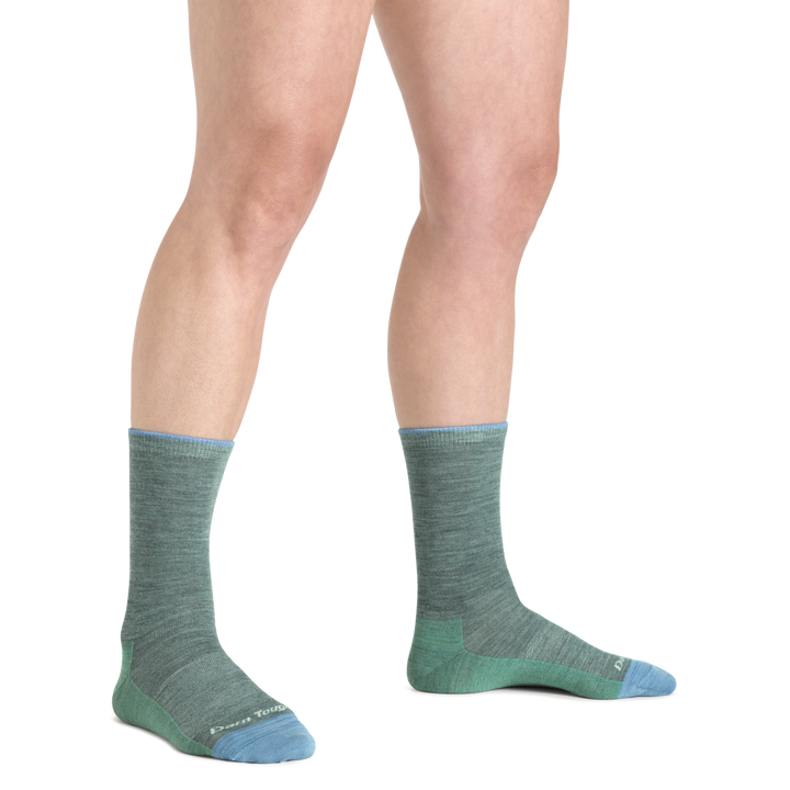 Model wearing Women's solid Basic Crew Lightweight Lifestyle sock in Seafoam with blue accents