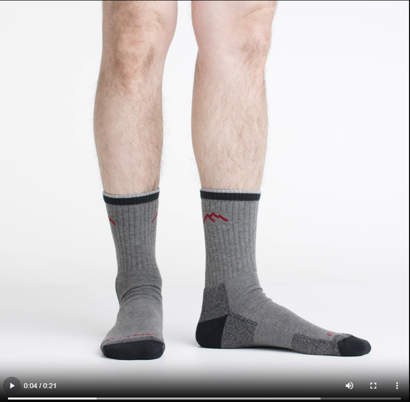 Video of model wearing hiker micro crew socks in gray/black, showing a 360 degree view of the socks.
