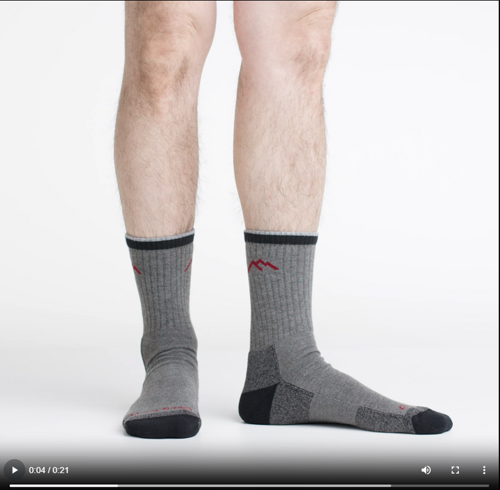 Video of model wearing hiker micro crew socks in gray/black, showing a 360 degree view of the socks.