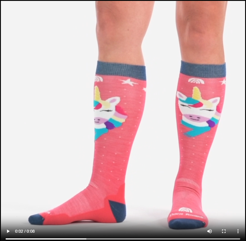 Video of model wearing kids magic mountain over the calf socks, walking around to show all angles of the socks.