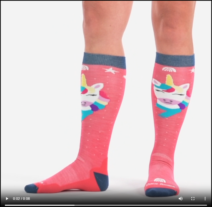 Video of model wearing kids magic mountain over the calf socks, walking around to show all angles of the socks.
