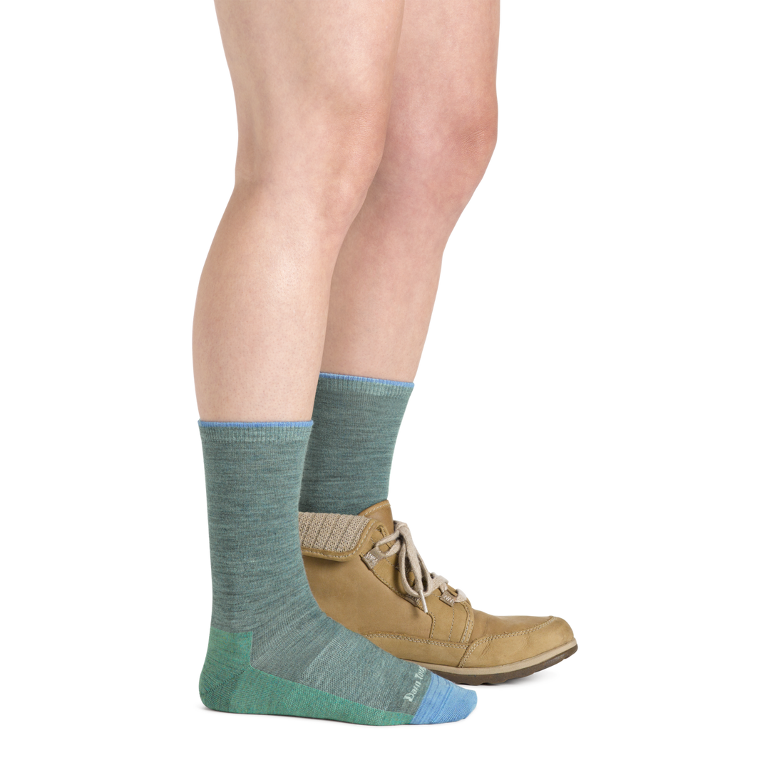 Model wearing Women's solid Basic Crew Lightweight Lifestyle sock in Seafoam with one casual boot