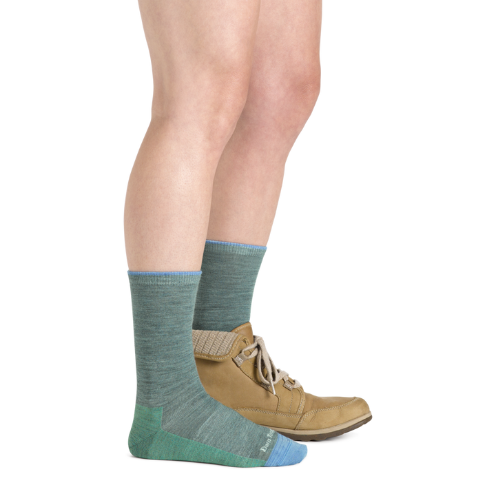 Model wearing Women's solid Basic Crew Lightweight Lifestyle sock in Seafoam with one casual boot