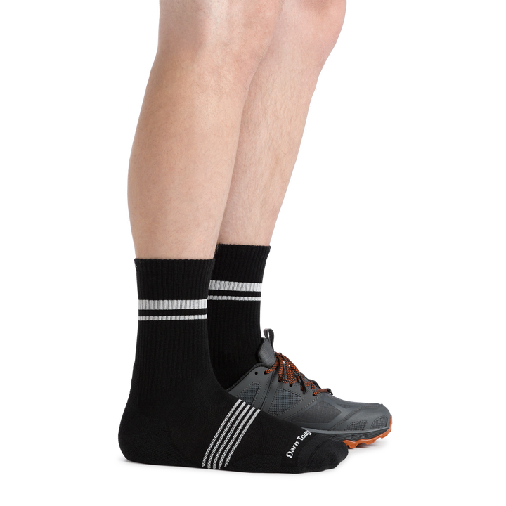 Man facing right wearing Men's Element Micro Crew Lightweight Running Sock in black and a hiking shoe on the left foot