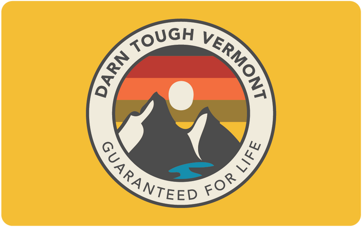 yellow darn tough physical gift card with sunset ridge mountain design and lifetime guarantee