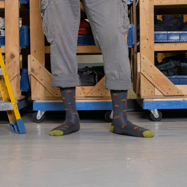 Close up shot of model standing in the nantanna mill wearing the men's beets crew lifestyle sock in graphite