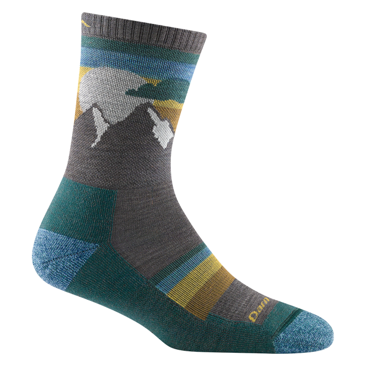 Studio shot of women's sunset ledge micro crew in taupe. It has grey and white mountains, and teal and gold striped accents.