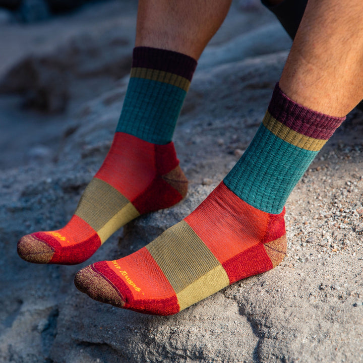 Side shot of model wearing men's heady stripe hiking sock in teal