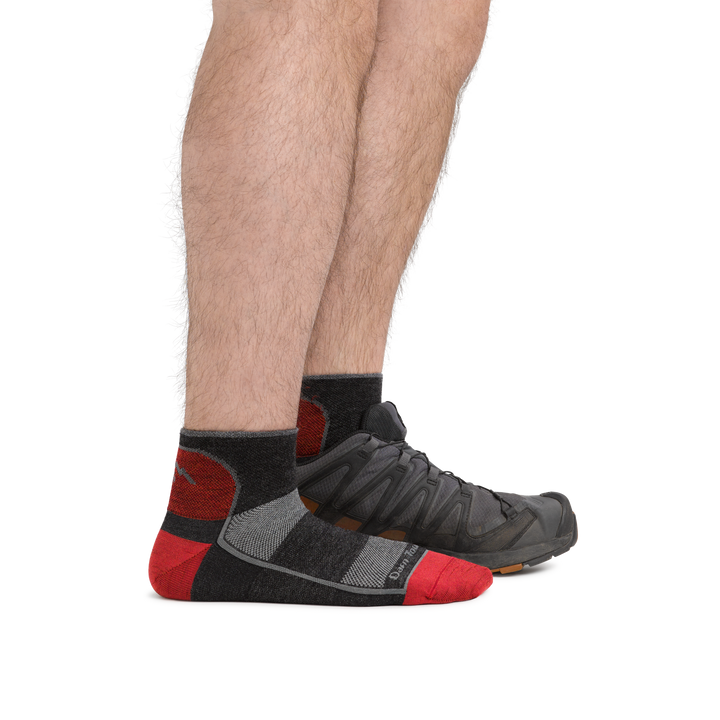Man standing with front foot barefoot and back foot with an athletic sneaker, wearing 1715 Quarter Lightweight Athletic Sock in color Team DTV, showing the quarter sock height hits just above the ankle.