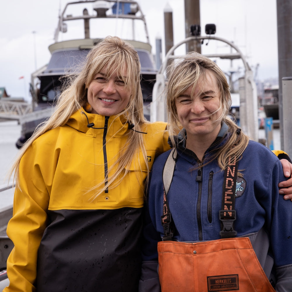 The two Salmon Sisters smiling in front of their boat